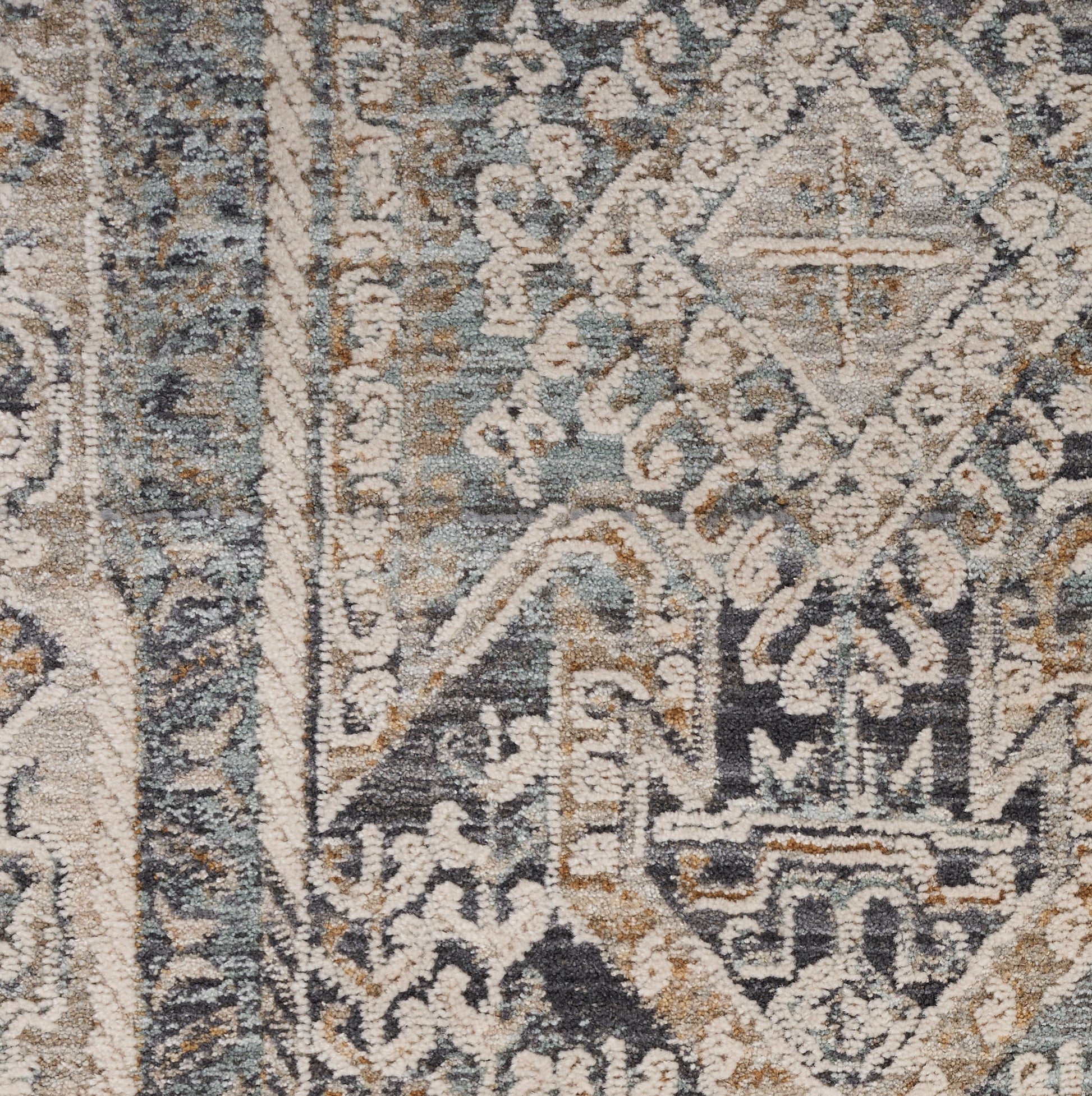 Muted blue-gray and beige oriental rug with diamond medallion and floral motifs, woven texture.