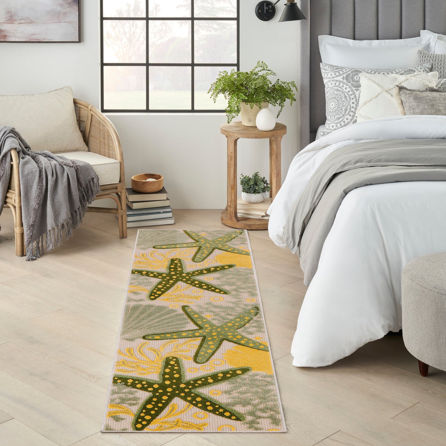 Beachy outdoor 6' runner rug with green starfish motifs and yellow dotted edges on a beige background.