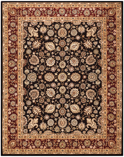 Rectangular Persian-style rug with black central field, ivory-gold floral motifs, and beige, gold, burgundy borders.