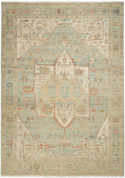Pastel oriental rug with pale blue and cream tones, central medallion, floral motifs, decorative border and fringed edges.