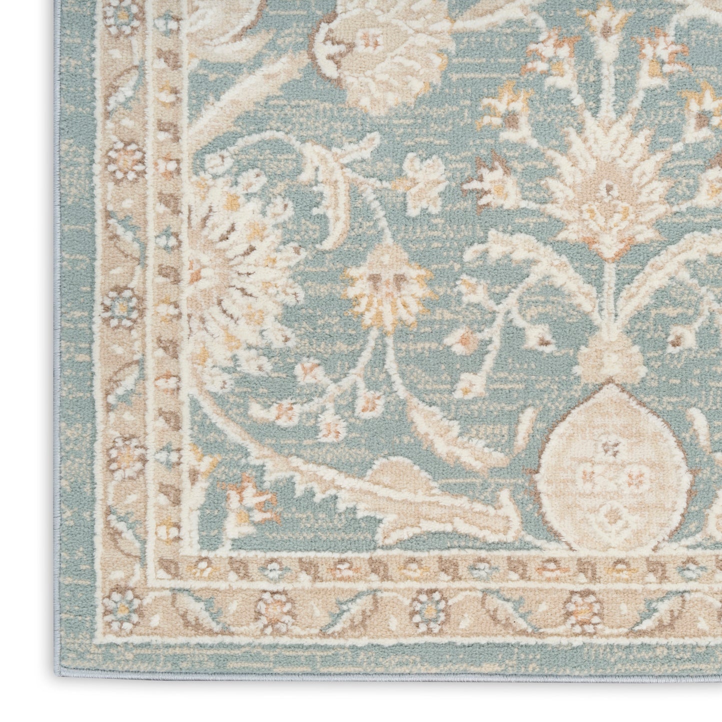 Teal blue oriental rug corner with ivory floral motifs and beige borders in vintage style.