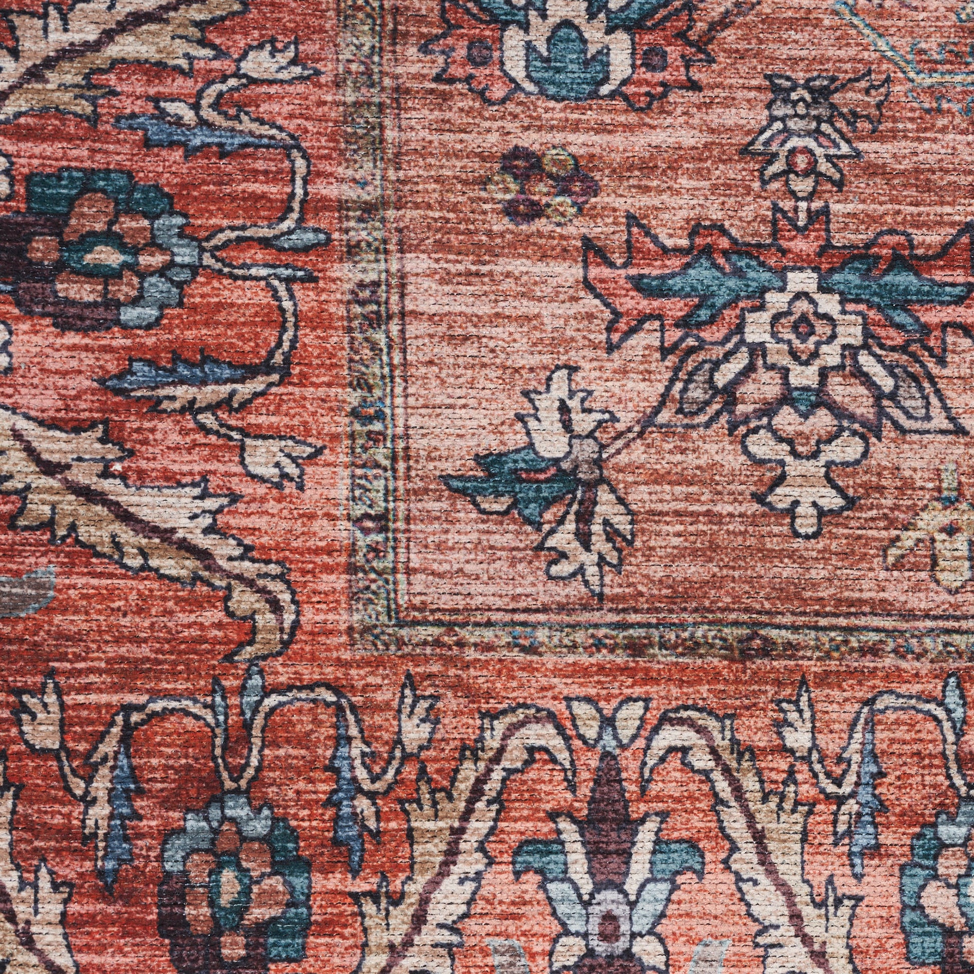 Close-up of a woven rust-red oriental rug with blue and teal floral motifs and decorative border.