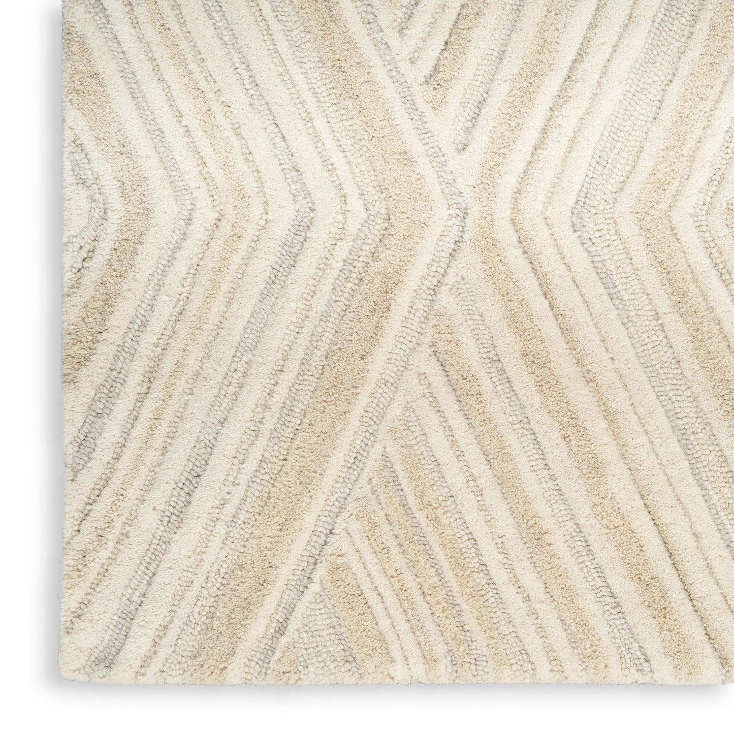 Cream and beige textured rug with raised chevron pattern and plush pile.