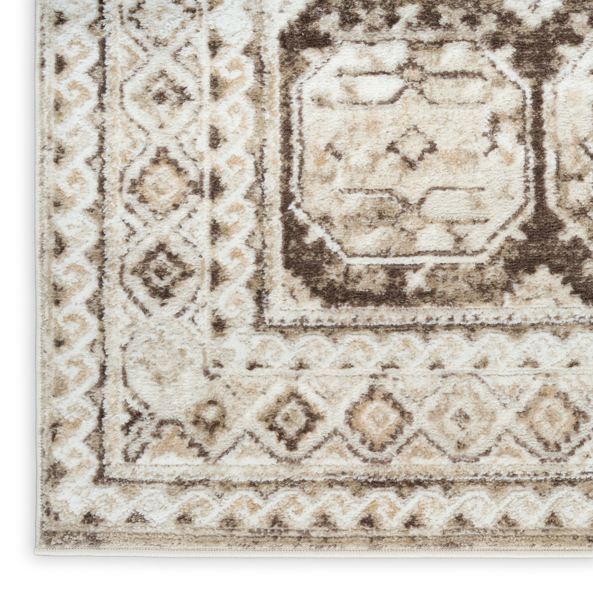 Beige and brown geometric area rug with a distressed central medallion and diamond border.