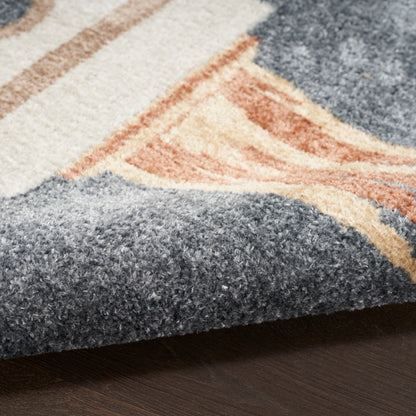 Close-up of a tufted area rug in blue & peach & cream geometric pattern with a folded edge.