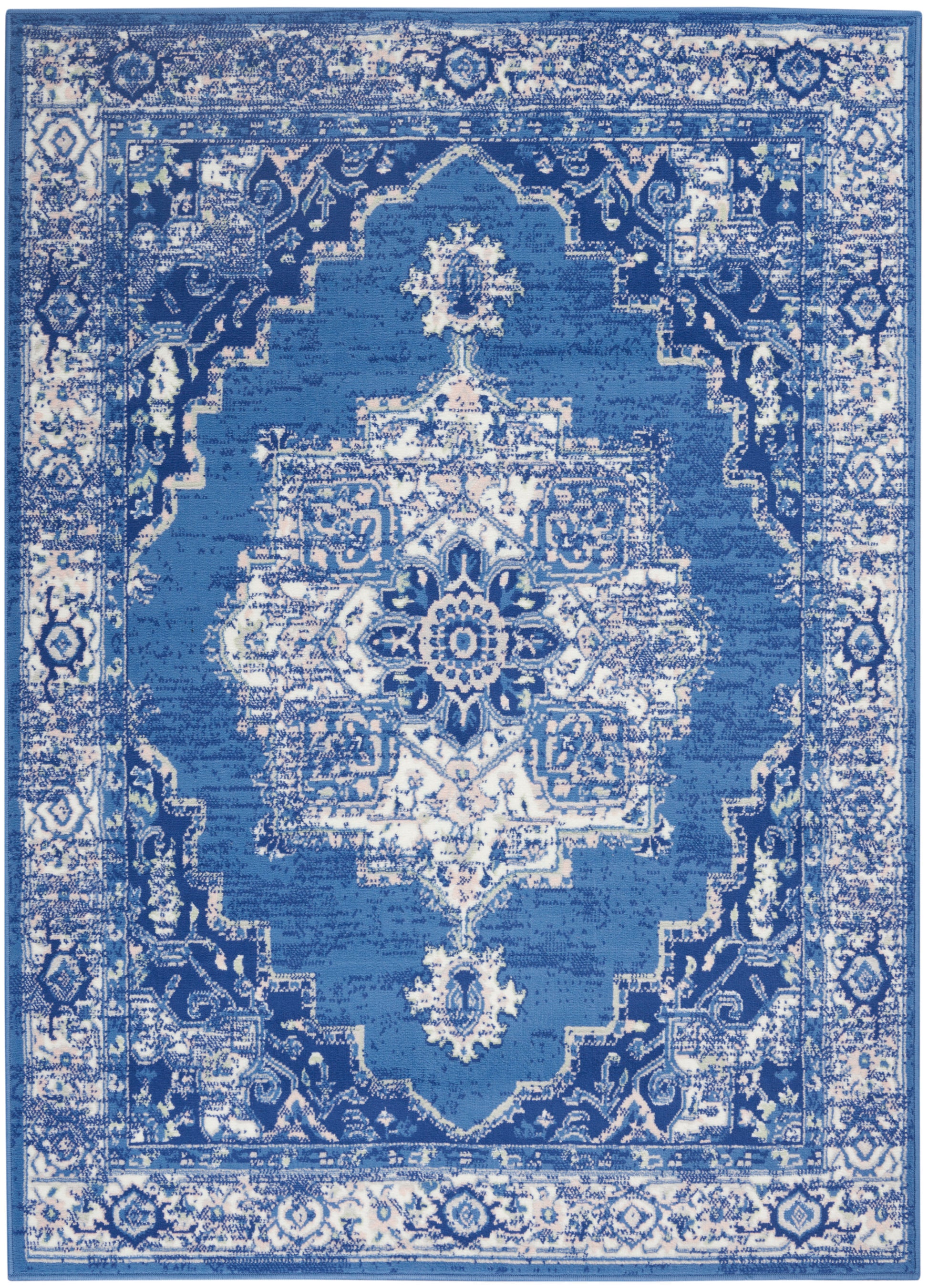 Blue and white Persian-style area rug with central medallion, ornate border, vintage distressed finish.