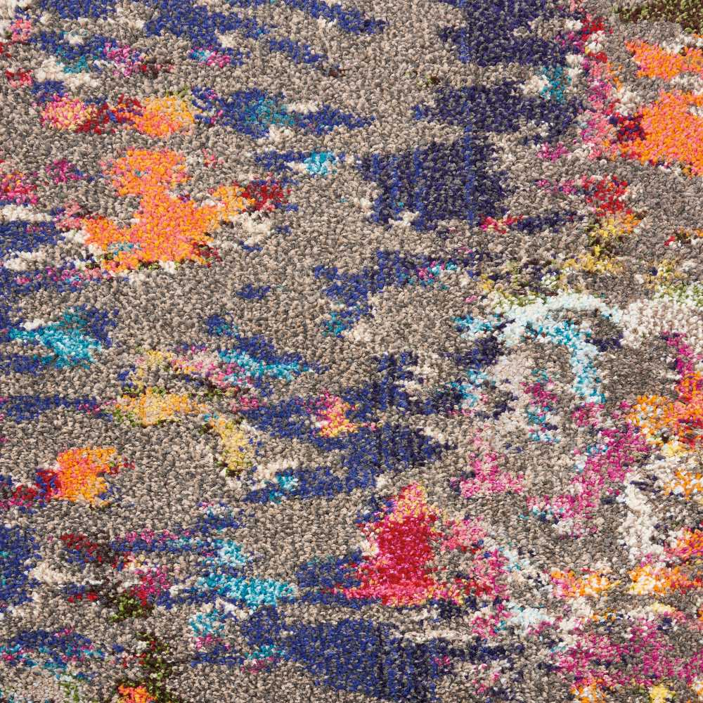 Abstract multicolor shag rug with gray base and vibrant orange, pink, and blue patches; high-pile tufted decor.