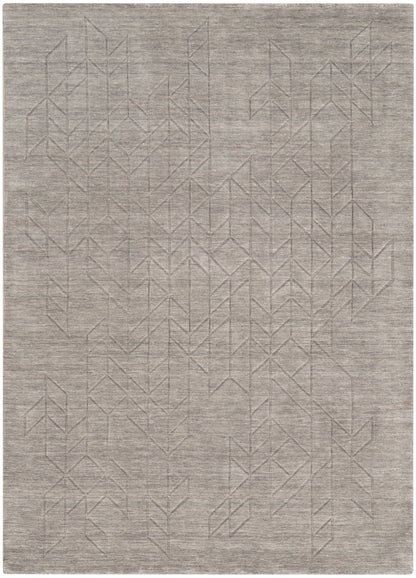 Taupe area rug with a soft, textured weave and faint pale gray geometric chevron pattern.