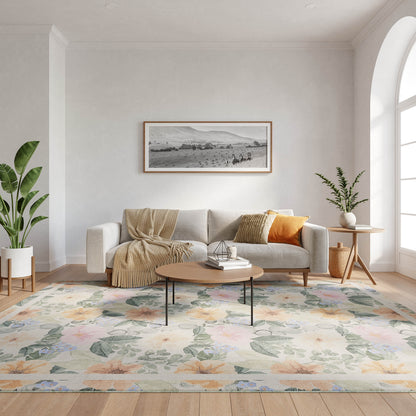 Cozy living room with beige sofa, orange cushion, throw, round wood coffee table, floral rug, plants, arched window.