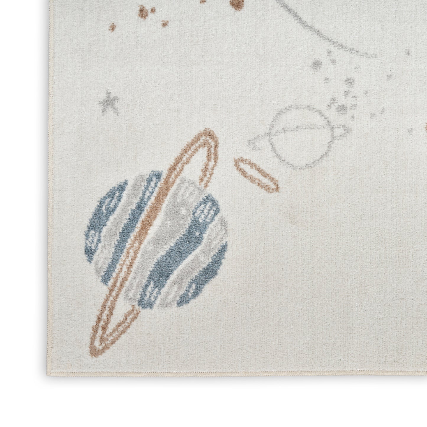 Beige woven textile rug with abstract celestial motif: muted blue planet shapes, brown rings, and speckled marks.