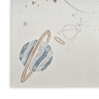 Beige woven textile rug with abstract celestial motif: muted blue planet shapes, brown rings, and speckled marks.