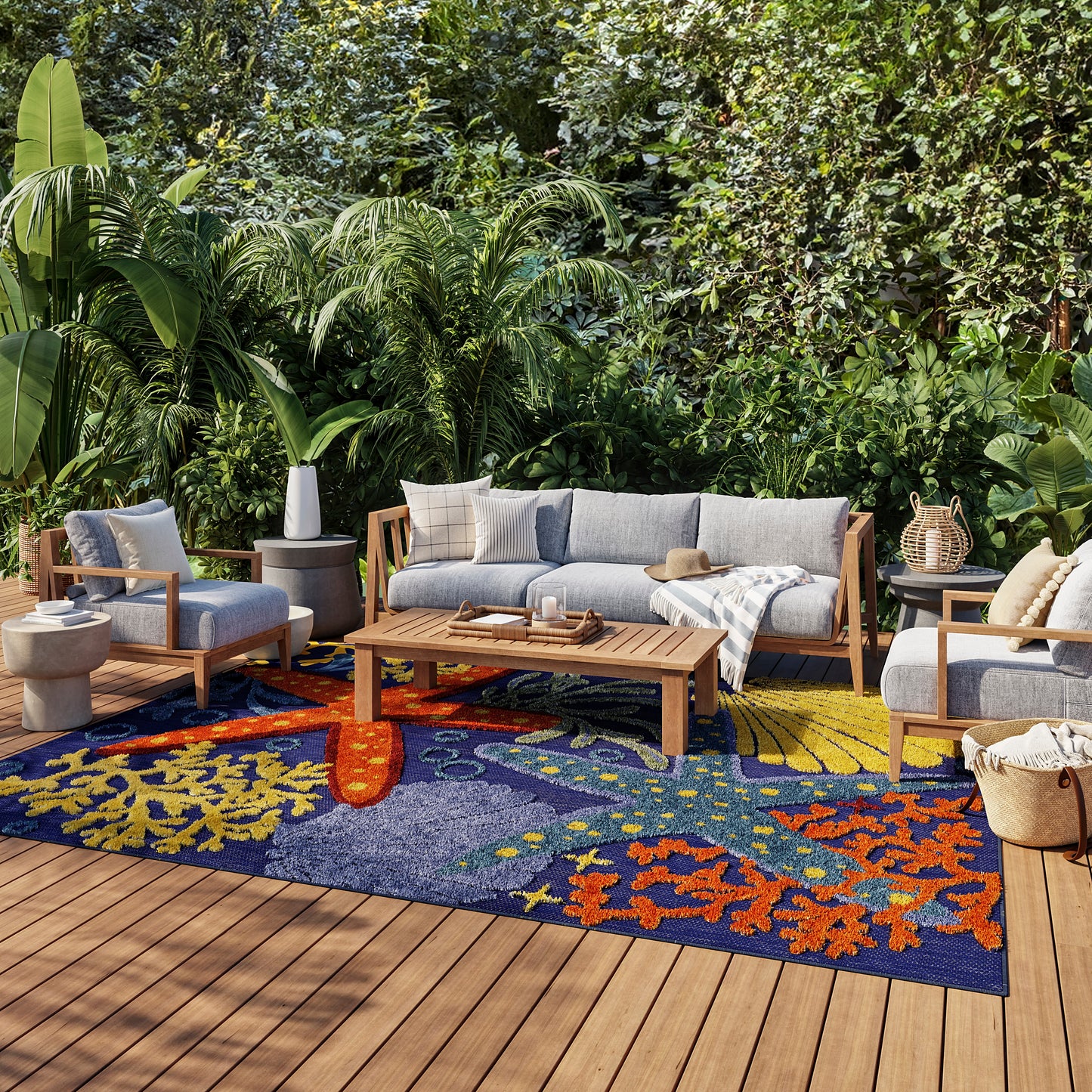 Outdoor rug, 9' x 12', blue with orange patterns, greenery in the background.