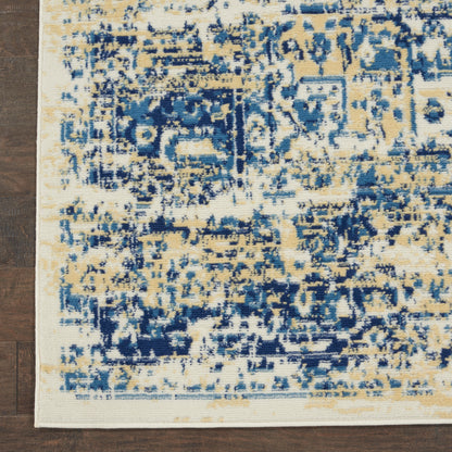 Rectangular distressed blue and beige rug with cream border on dark wood floor.