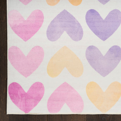 Pastel heart pattern rug for kids with pink, peach and lavender hearts on a light background; wood edge visible