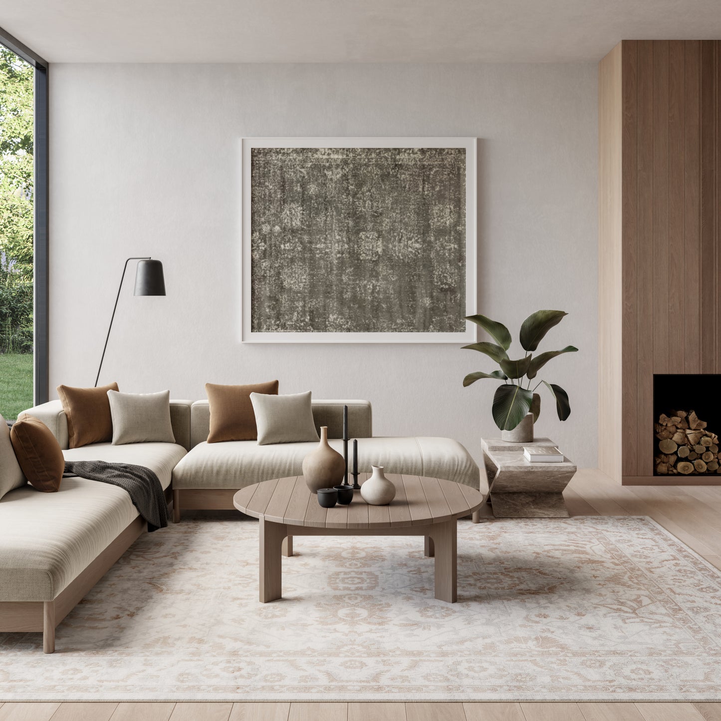 Neutral modern living room with beige sectional, round wood coffee table, abstract art, floor lamp, plant, and log fireplace.