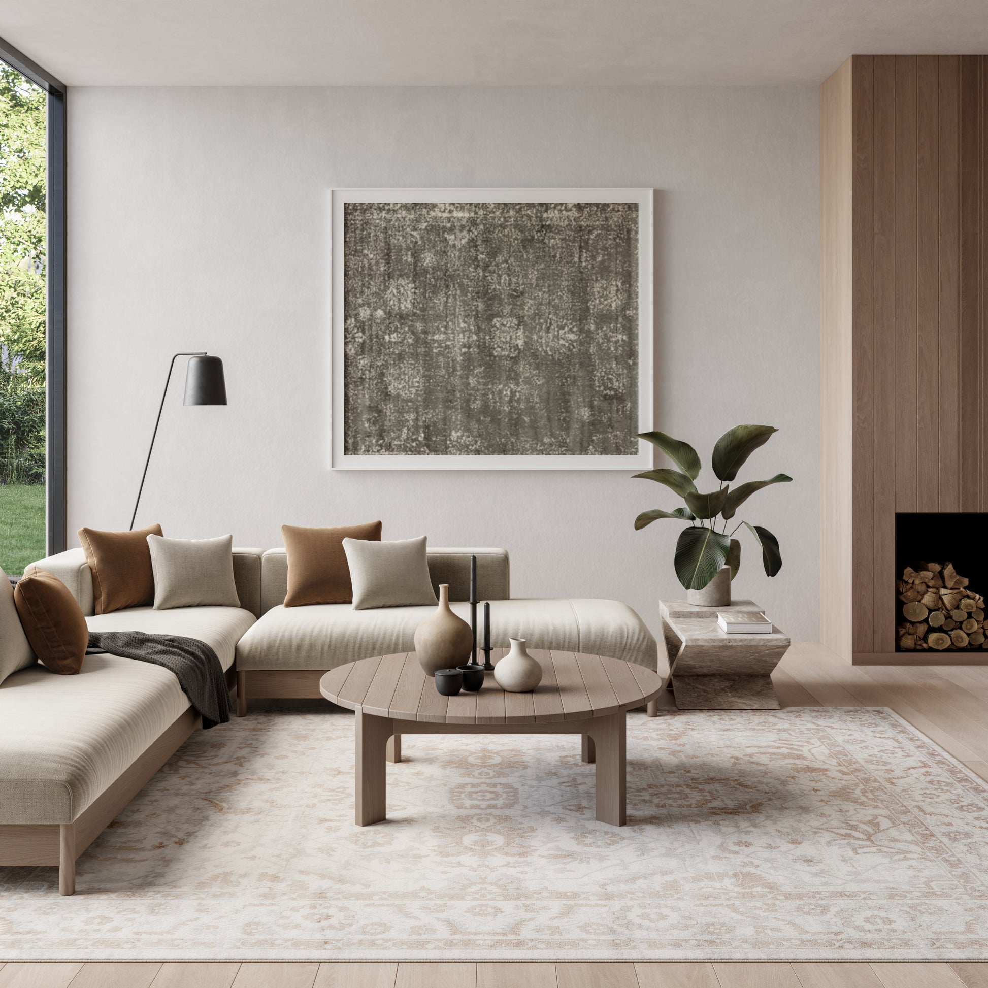 Neutral modern living room with beige sectional, round wood coffee table, abstract art, floor lamp, plant, and log fireplace.