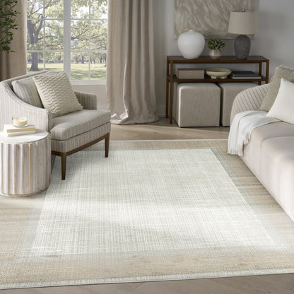 Neutral-toned living room with a large light woven area rug, cream sofa and armchair, and wooden console.