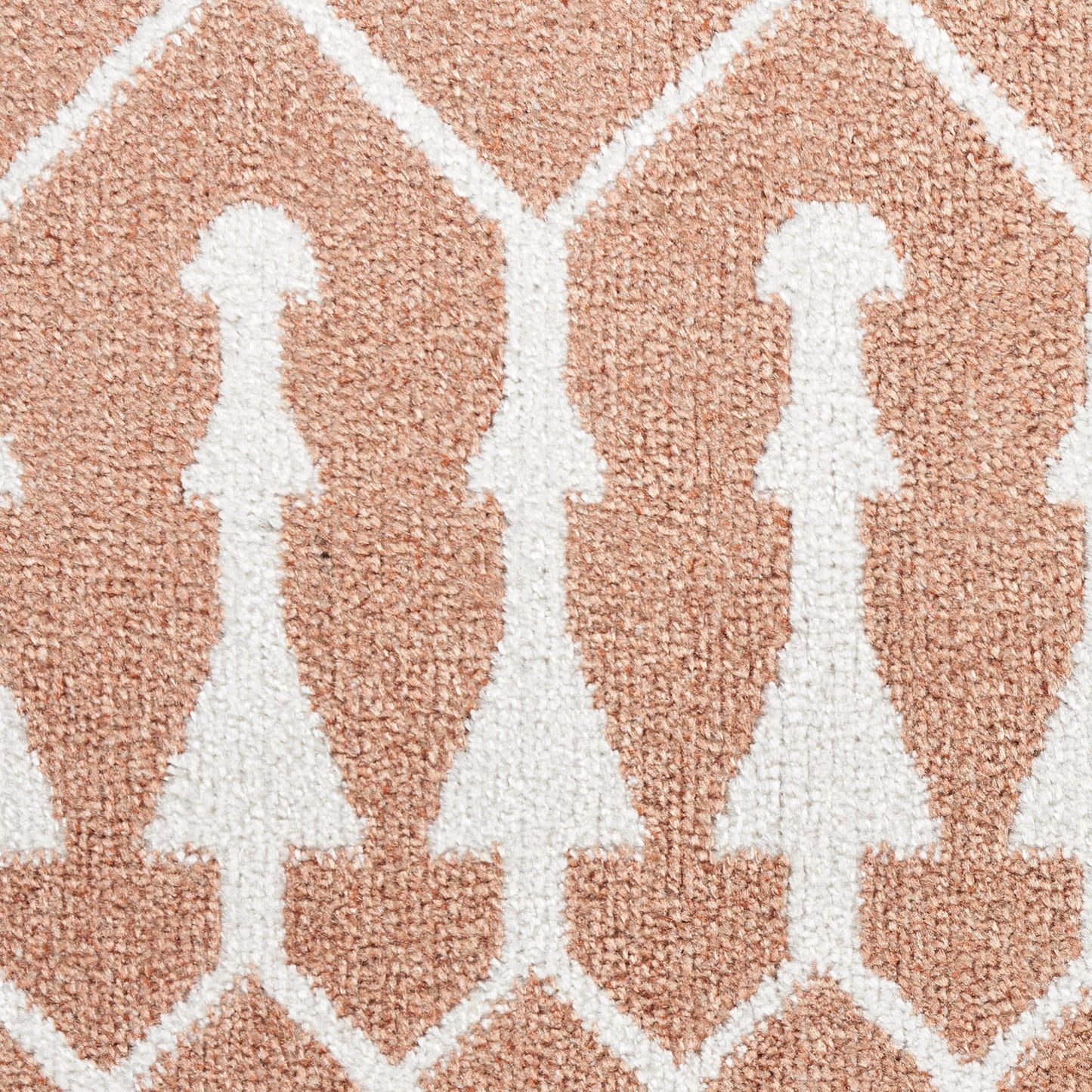 Soft peach rug with white stylized female silhouettes in a diamond lattice pattern.