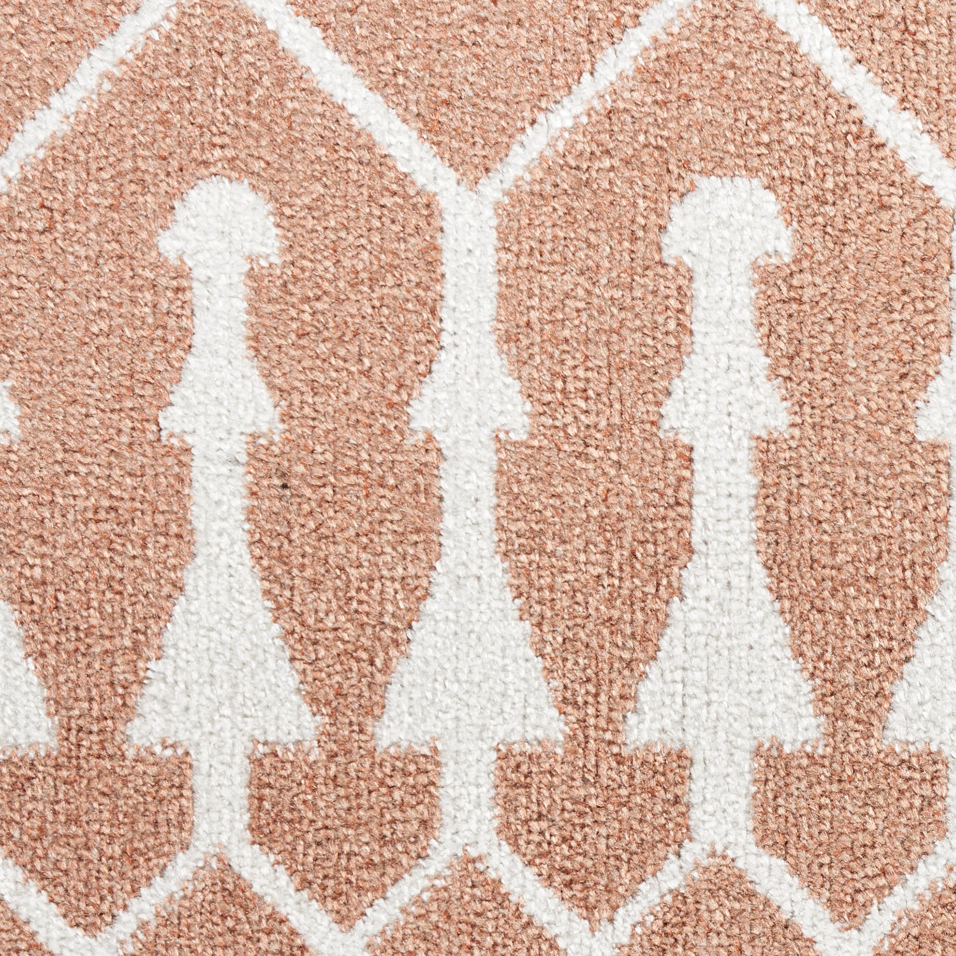 Soft peach rug with white stylized female silhouettes in a diamond lattice pattern.