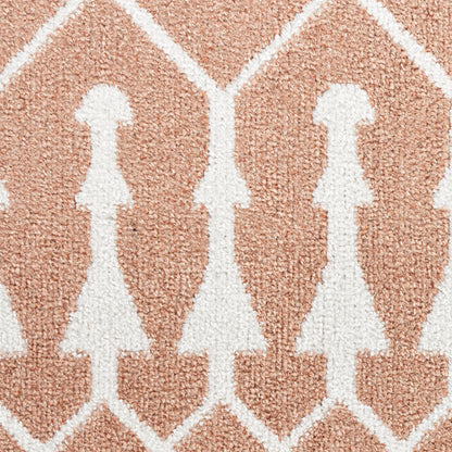 Soft peach rug with white stylized female silhouettes in a diamond lattice pattern.
