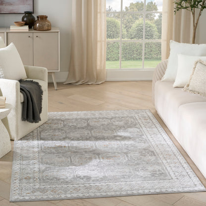 Rectangular light gray oriental-style area rug with ivory and cream motifs in a bright, neutral living room.