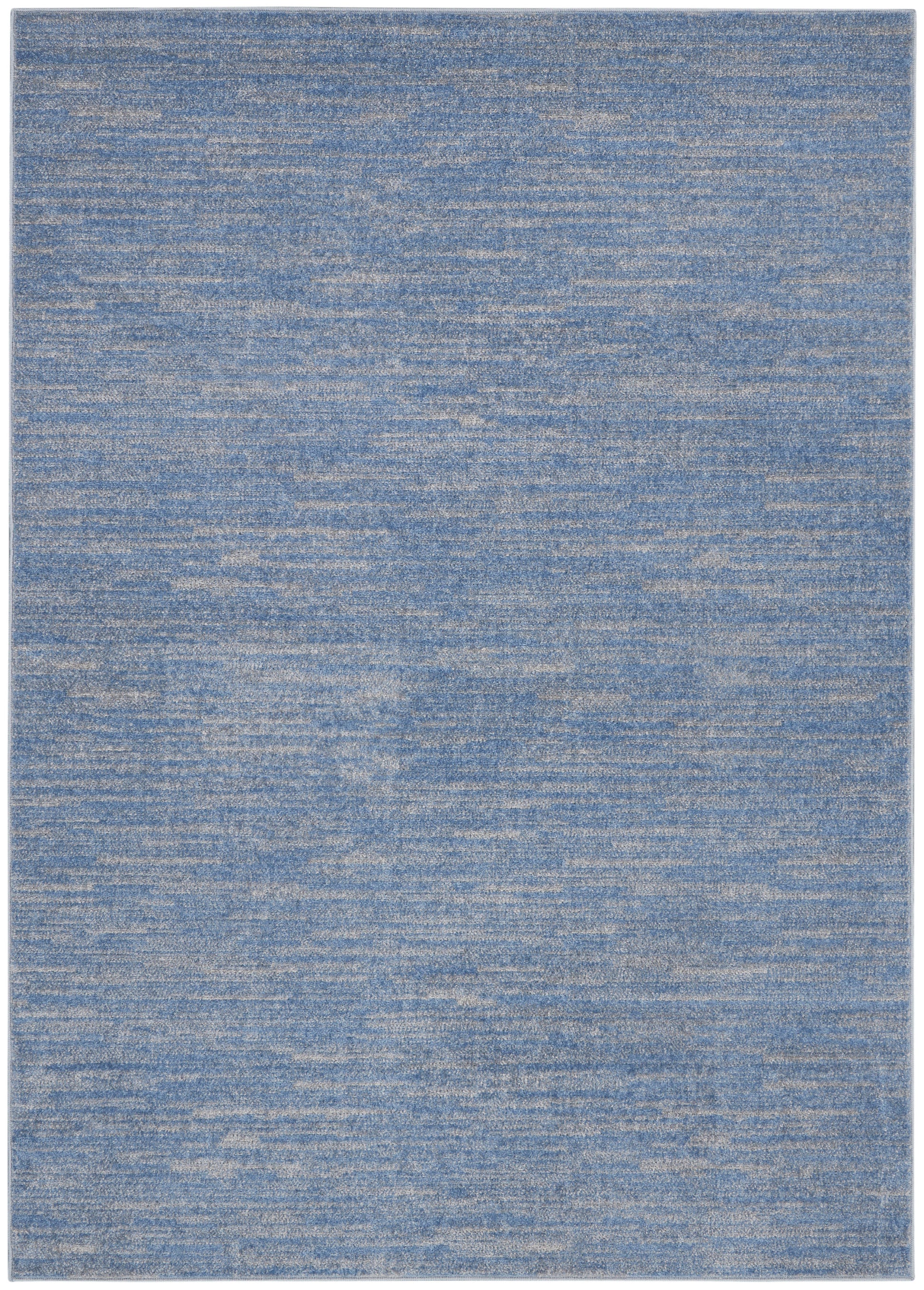 Blue woven area rug with variegated denim tones and beige heathering; rectangular, modern casual decor.