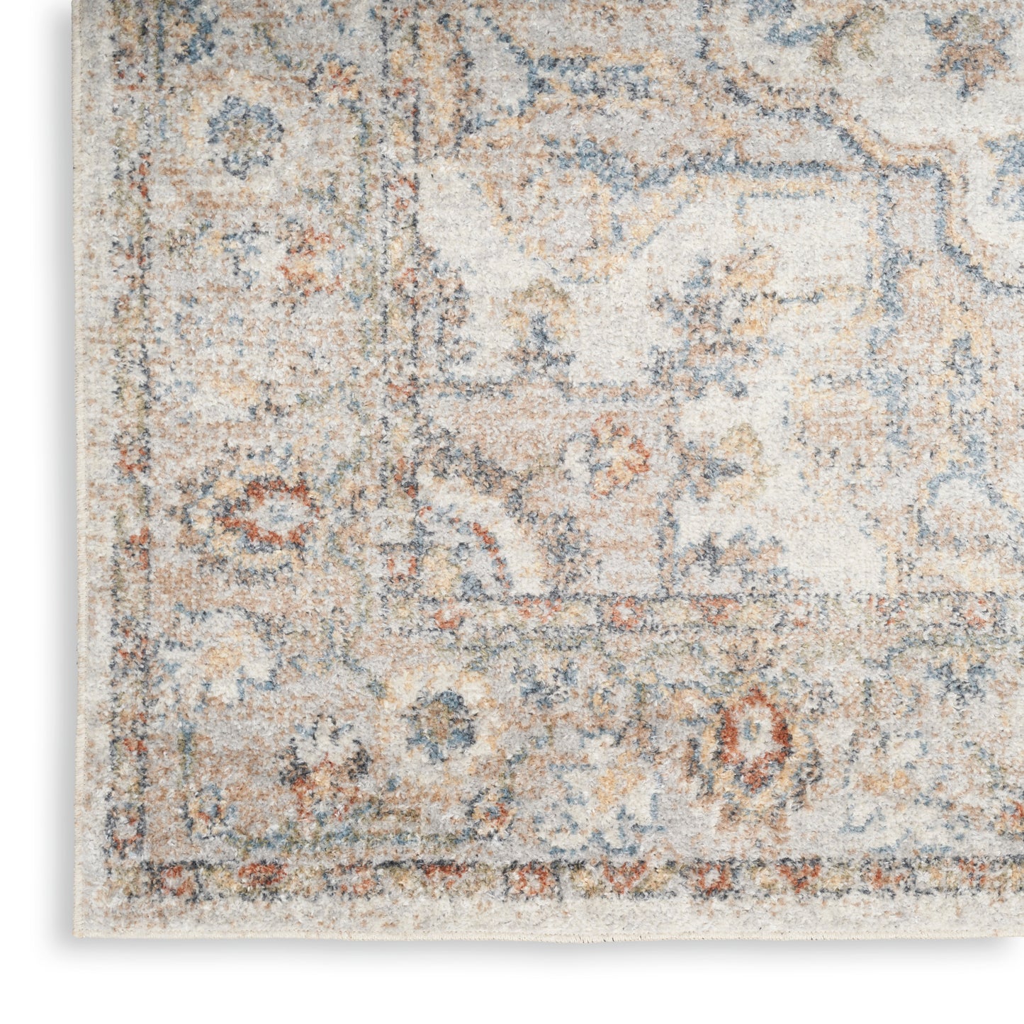 Rectangular distressed beige oriental rug with blue and rust floral medallion pattern.