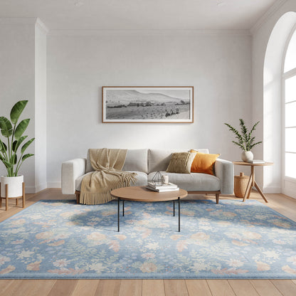 Modern living room with light gray sofa, beige throw and orange cushion, blue floral rug, round wood coffee table, potted plants, arched window.