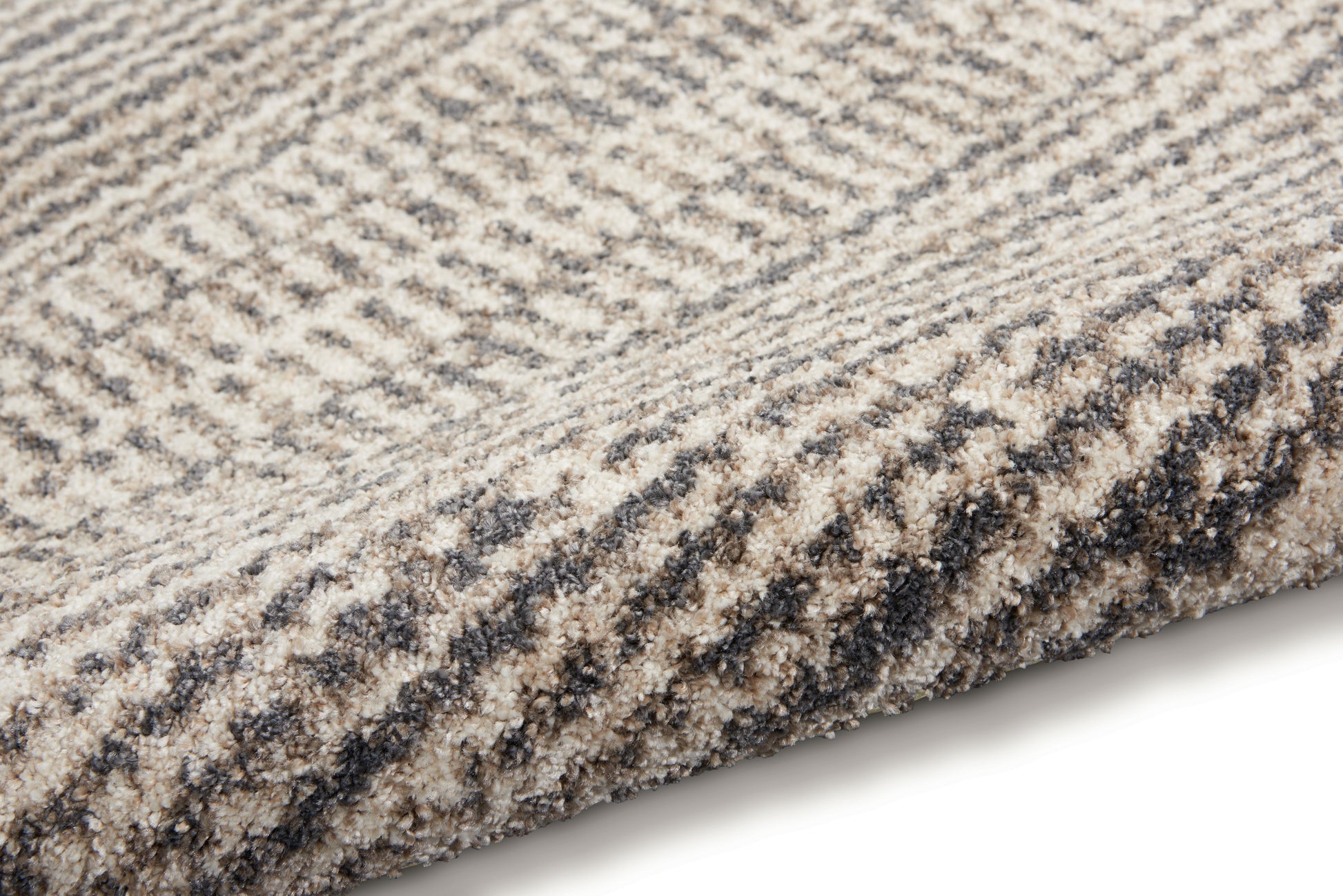 Beige and taupe plush rug with subtle gray striped herringbone pattern.
