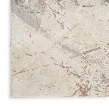 Abstract beige area rug with taupe, gray and brown marbling; soft plush, modern decor.