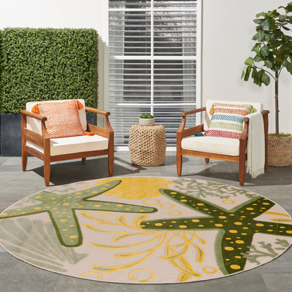 Round outdoor rug with yellow-green starfish motif; wooden-armchairs with white cushions and colorful pillows.