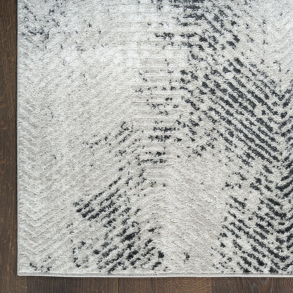 Cream and charcoal abstract patterned area rug with soft texture on dark wood floor.