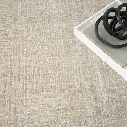 Beige textured rug with a white rectangular tray containing coiled black cords.