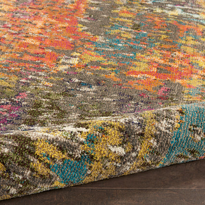 Multicolor tufted area rug with abstract pattern in pink, orange, teal, yellow; thick folded edge on dark wood floor.