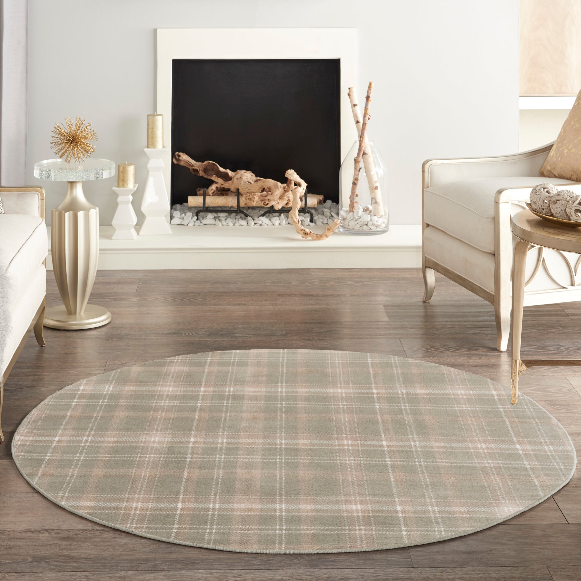 Round plaid area rug in soft sage, taupe & beige tones, laid on dark wood flooring in a cozy living room.