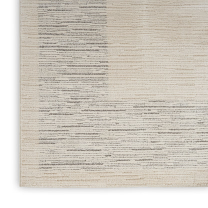 Cream-beige woven rug with subtle gray horizontal brush lines; modern minimalist texture.