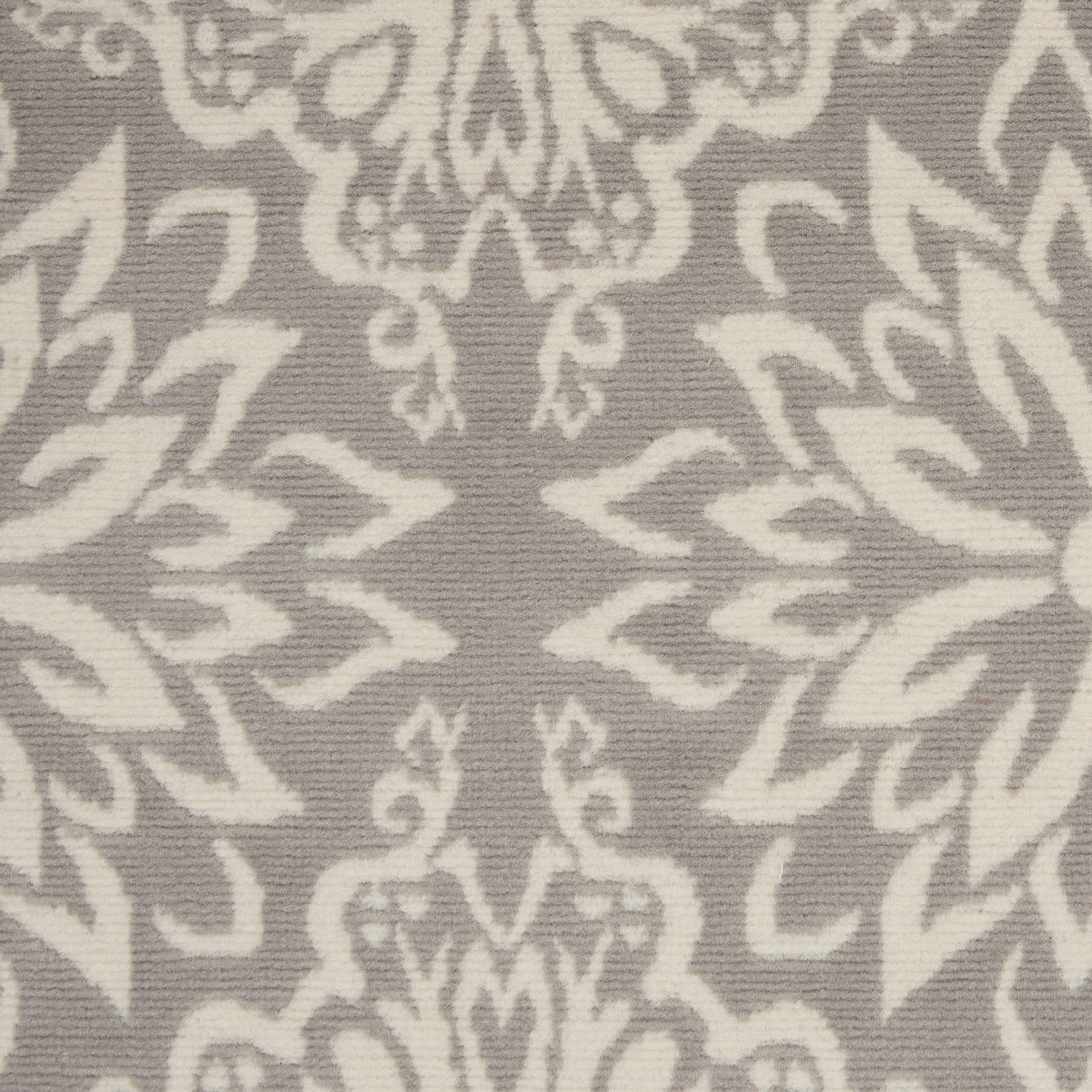 Grey textile with ivory damask pattern and scrolling floral motifs.
