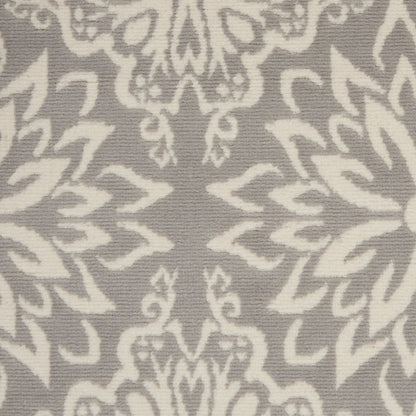 Grey textile with ivory damask pattern and scrolling floral motifs.