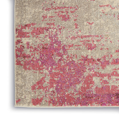 Rectangular beige distressed area rug with pink magenta abstract pattern; modern vintage look.