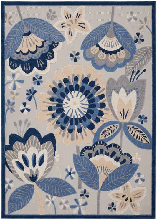 Rectangular rug in blue, beige and gray with floral pattern and navy border.