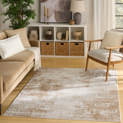 Neutral living room with tan sofa, light wood floors, beige rug, white cubby shelves and wicker baskets; wooden armchair.
