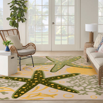 Outdoor coastal rug with oversized dark green starfish shapes and yellow dot accents on a beige base.