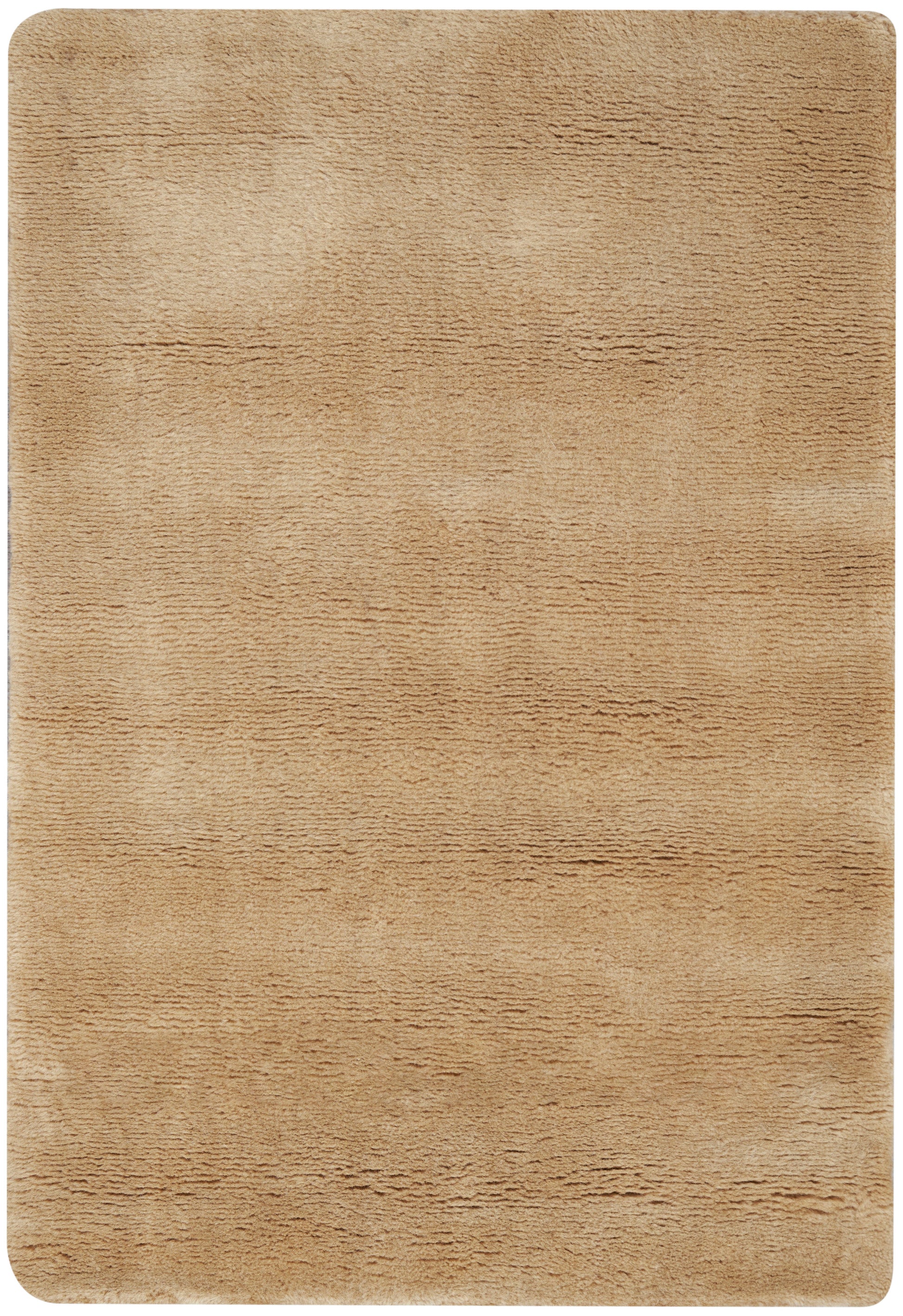 Tan plush rug with soft, textured pile and rounded corners.