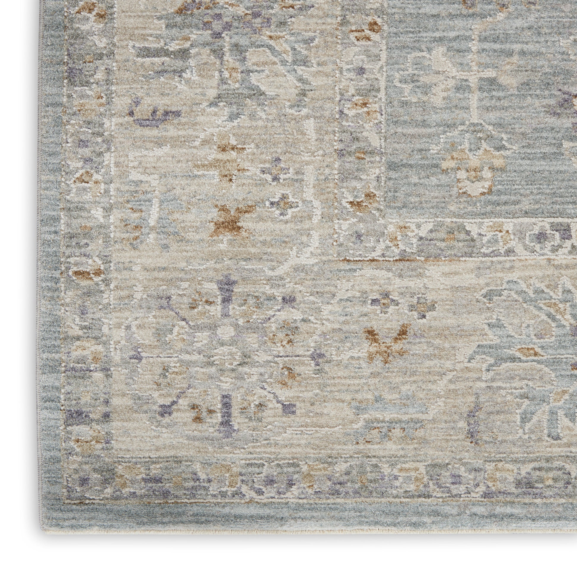 Pastel distressed area rug with ivory, blue-gray tones, lavender florals and ornate border; soft vintage look.