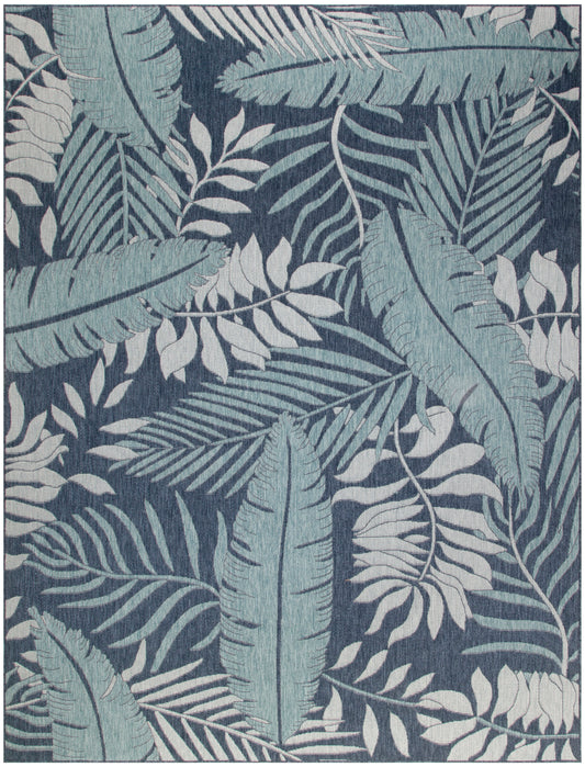 Dark navy rectangular rug with teal and pale blue tropical leaf pattern; woven botanical design for living room.