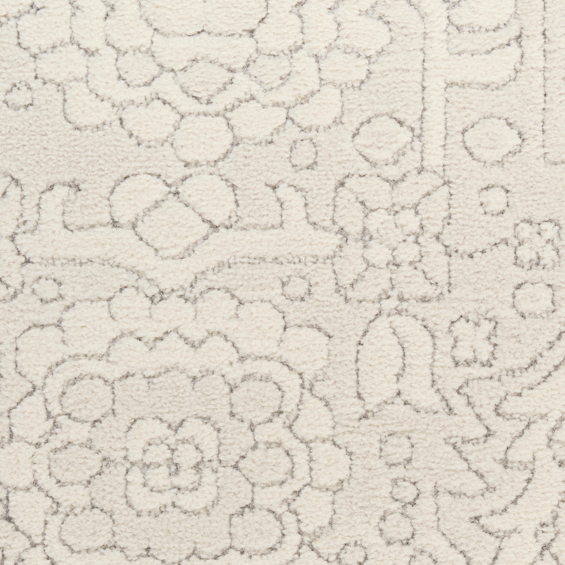 Cream textured shag rug with subtle ivory floral damask pattern and soft pile for living rooms.