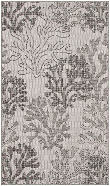Gray coral-pattern rug on light taupe background; woven coastal textile with botanical reef motif.