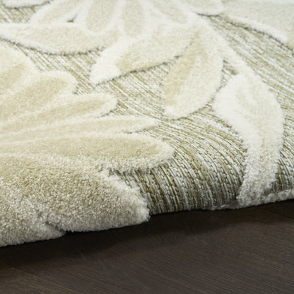 Cream outdoor rug with a raised leaf pattern on a woven beige backing.