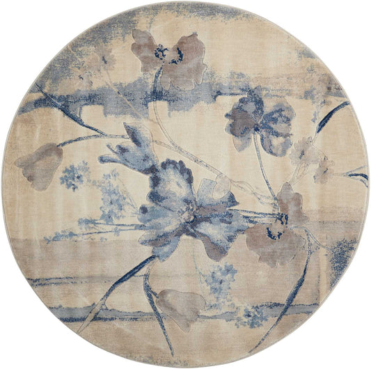 Round beige rug with blue floral pattern and watercolor-style vines.
