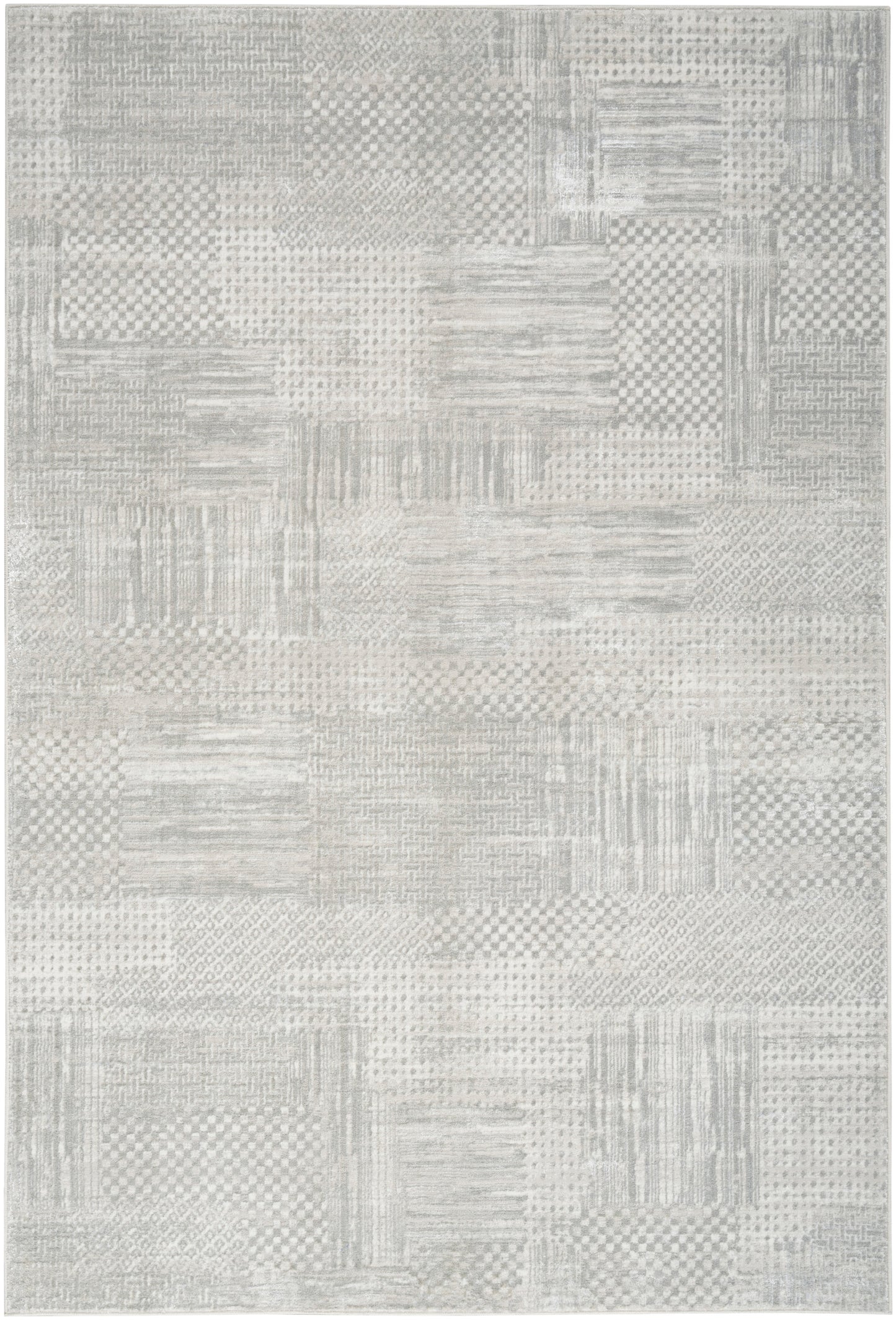 Light gray patchwork rug with subtle check, striped, and dotted patterns; woven texture for modern neutral decor.
